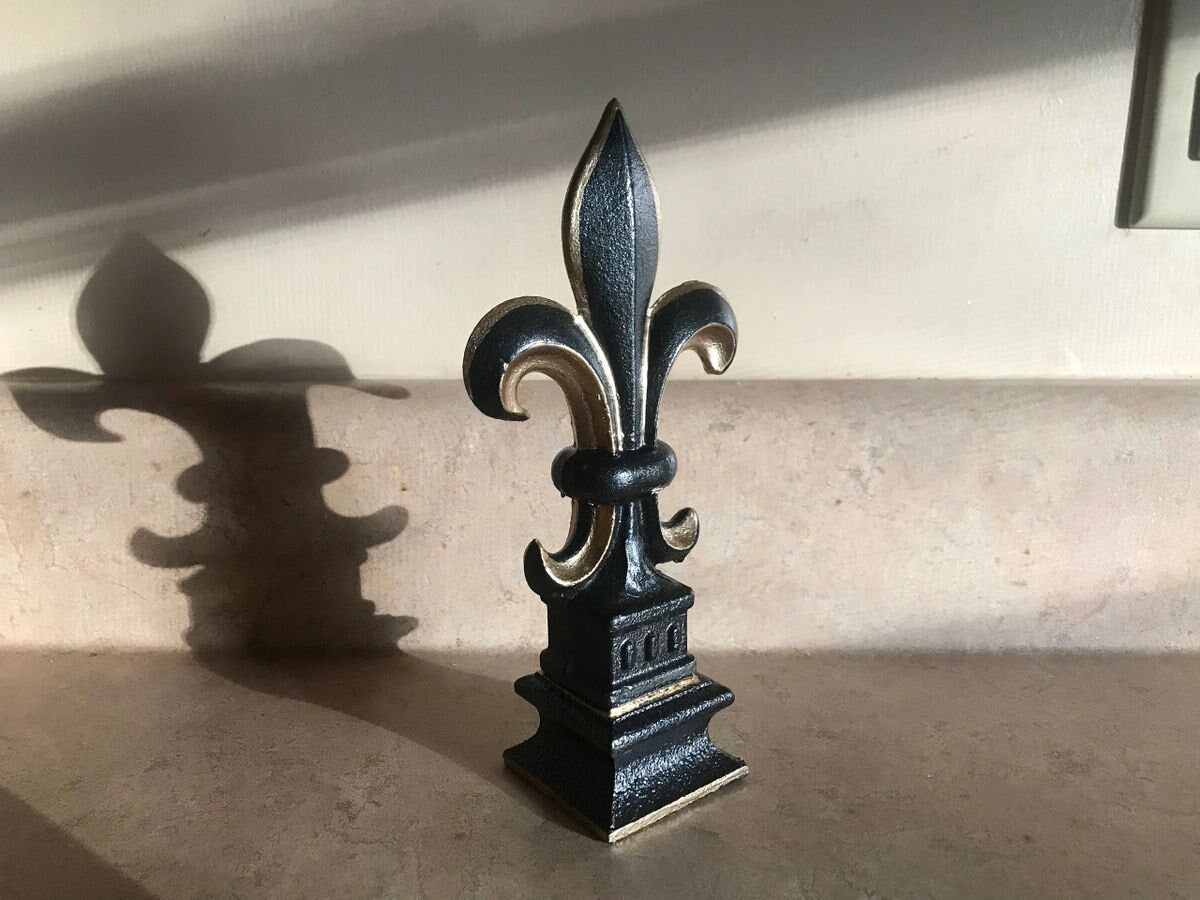 5 1/2 and 7 1/4 high cast iron Fleur de lis on pedestal. Beautifully hand painted with metallic gold accents