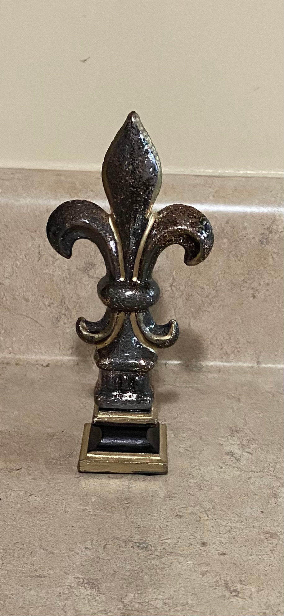 5 1/2 and 7 1/4 high cast iron Fleur de lis on pedestal. Beautifully hand painted with metallic gold accents