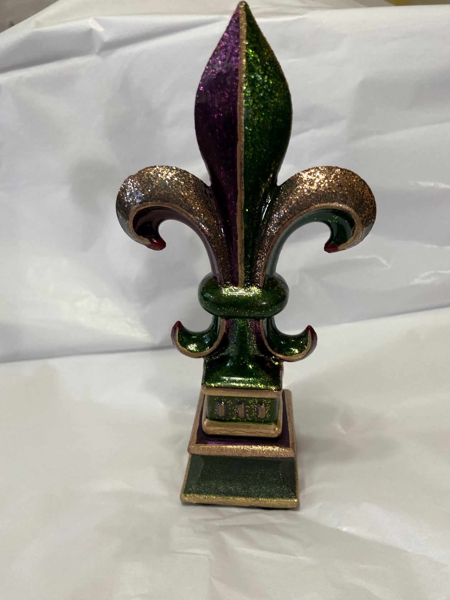 5 1/2 and 7 1/4 high cast iron Fleur de lis on pedestal. Beautifully hand painted with metallic gold accents