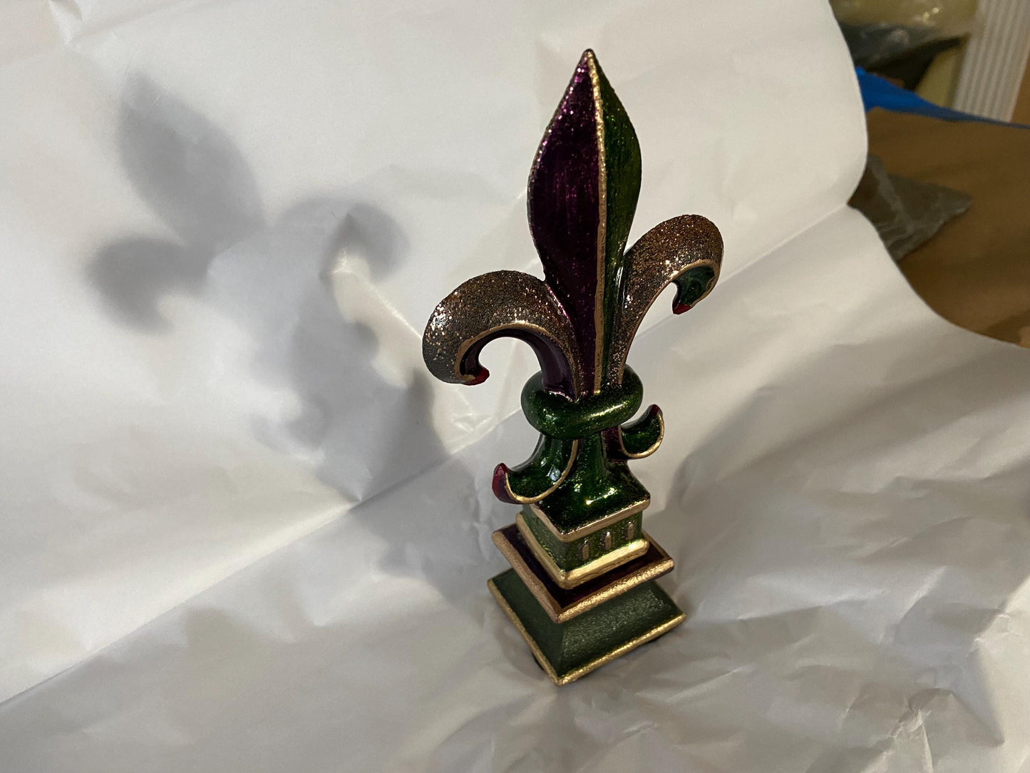 5 1/2 and 7 1/4 high cast iron Fleur de lis on pedestal. Beautifully hand painted with metallic gold accents