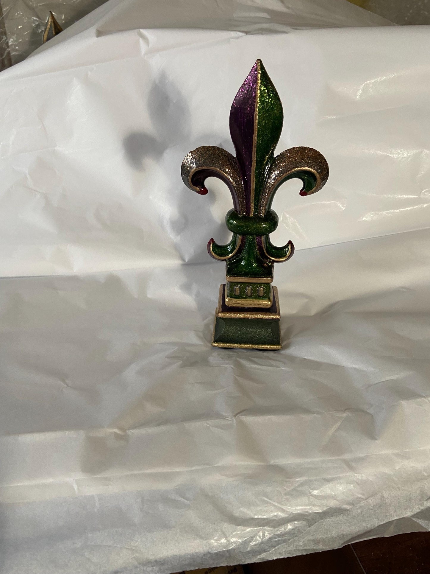5 1/2 and 7 1/4 high cast iron Fleur de lis on pedestal. Beautifully hand painted with metallic gold accents