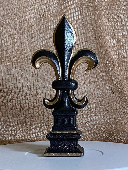 5 1/2 and 7 1/4 high cast iron Fleur de lis on pedestal. Beautifully hand painted with metallic gold accents